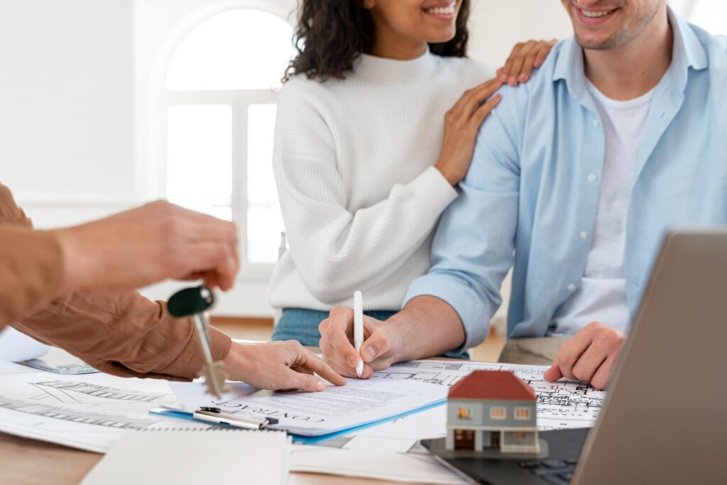 a couple signing a contract with a lender