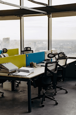 A modern office interior featuring desks, chairs, and clean lines in a professional setting