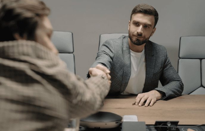 Two men shaking hands in a professional office setting