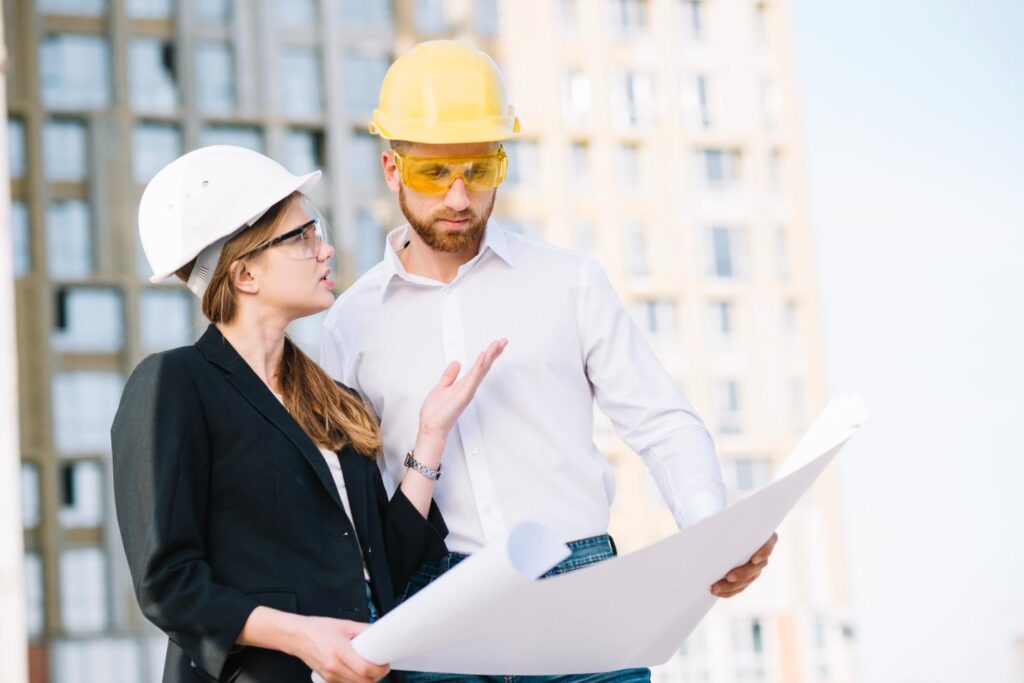 two individuals holding a blueprint