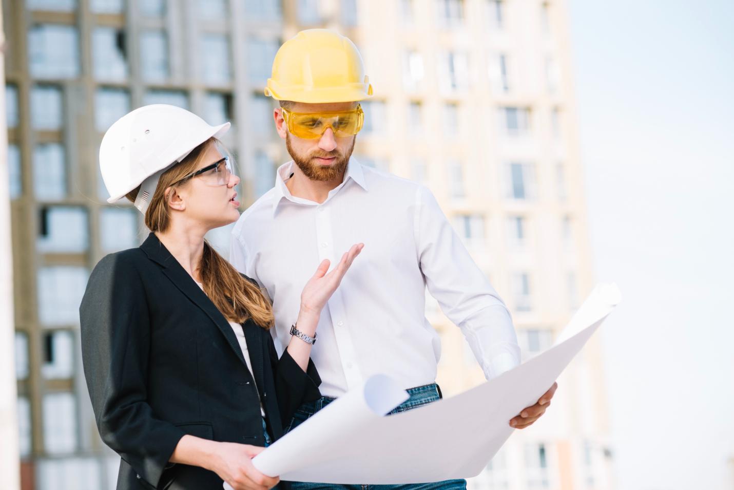 two individuals holding a blueprint