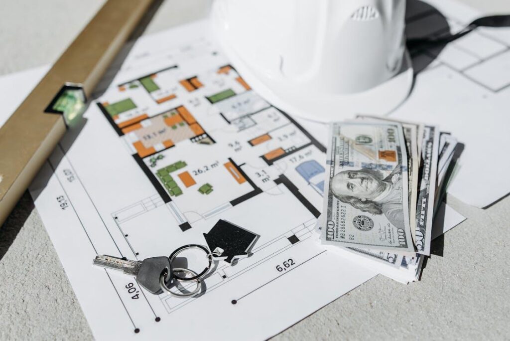 A floor plan with money and keys on it