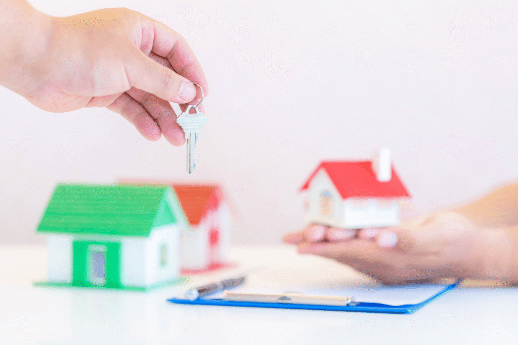 an individual holding a key to a property