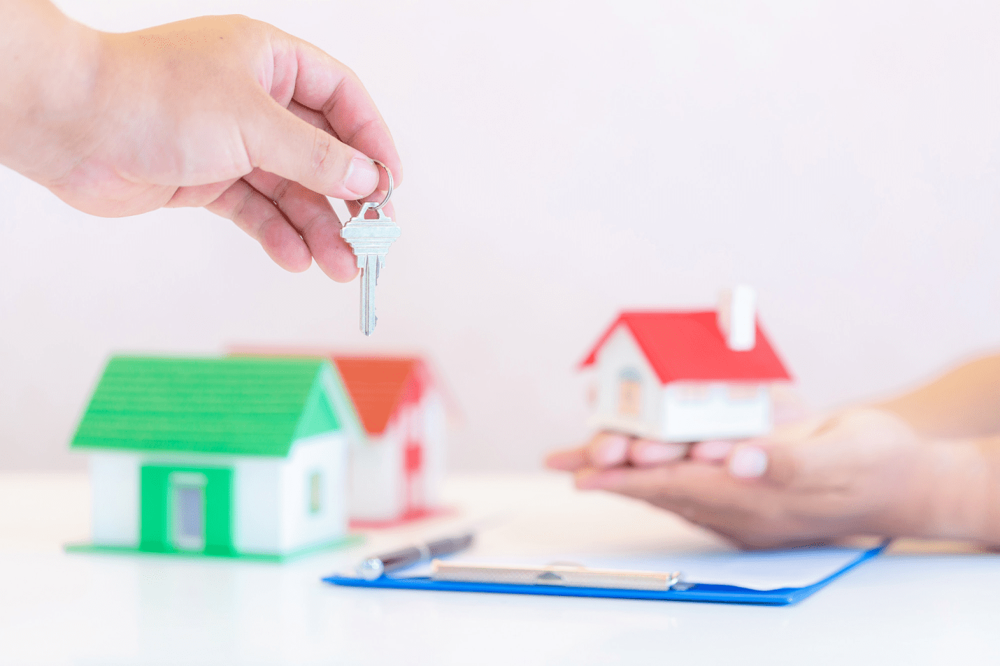 an individual holding a key to a property