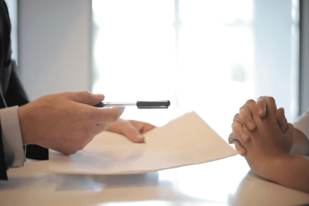 a lender from a bridge loan company handing over a document