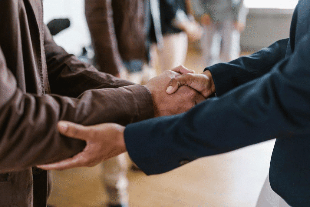 Businessman shaking hands during a meeting, representing a successful agreement.