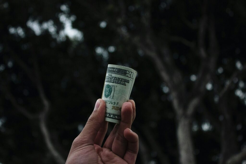 A person holding a wad of cash.