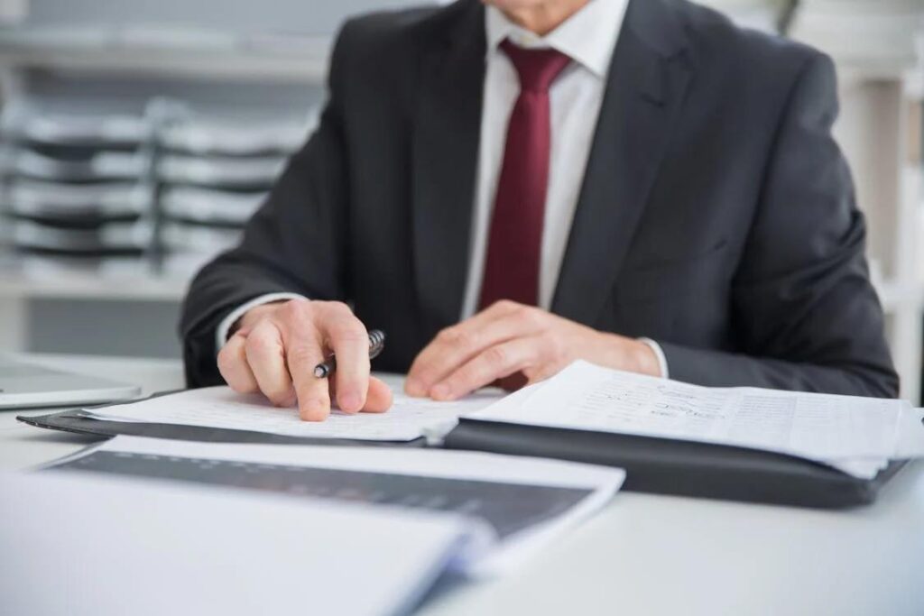 Borrower signing loan approval documents for new construction loan as a first-time builder
