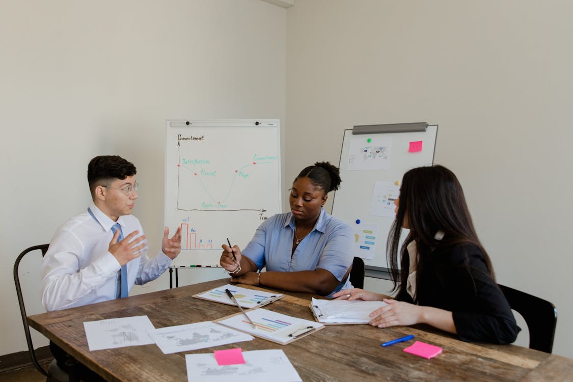 An image of three people during a meeting
