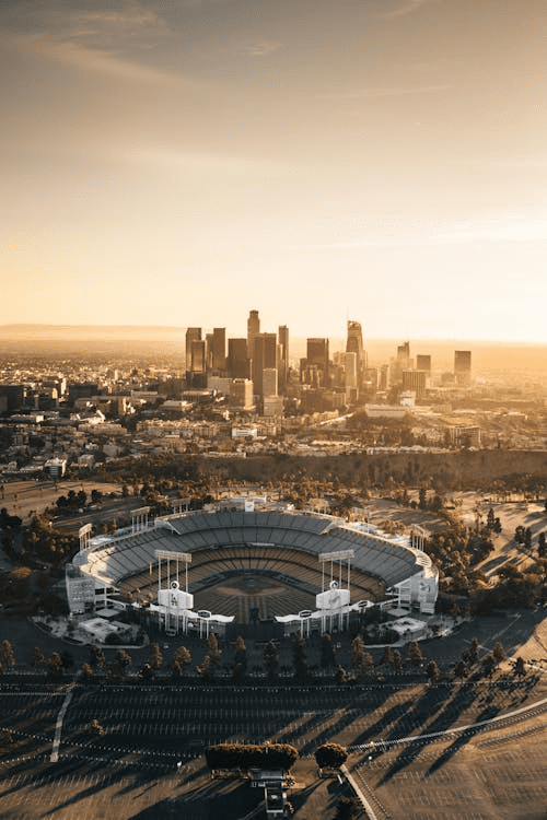 Panoramic skyline showing multiple U.S. cities at sunset.