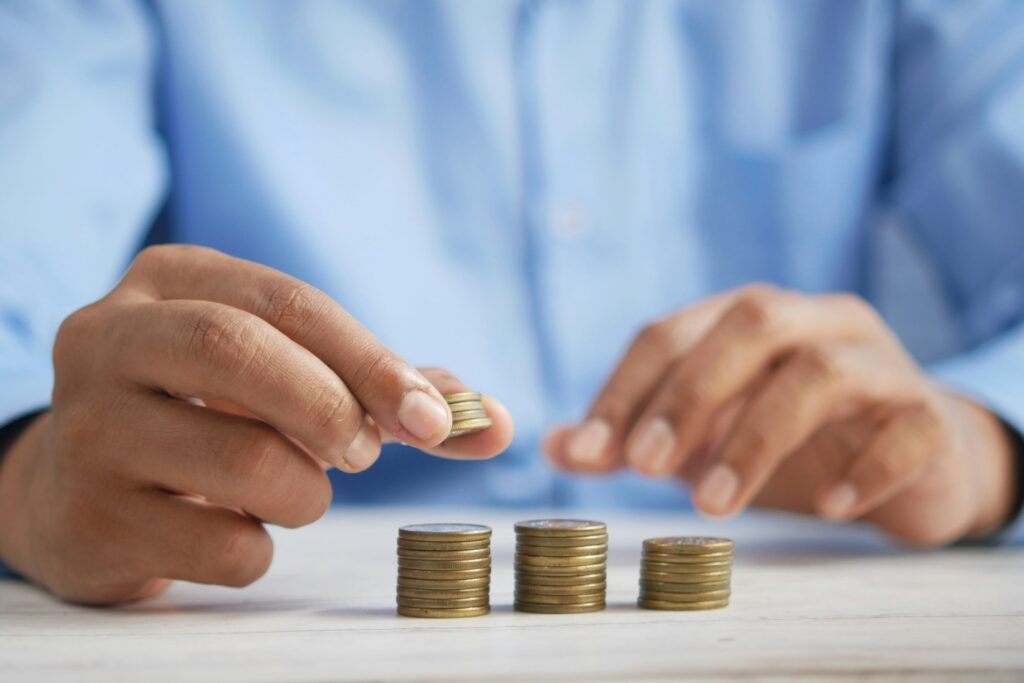 A person counting pennies on the table