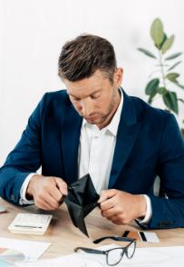 A man looking into an empty wallet while facing renovation delays