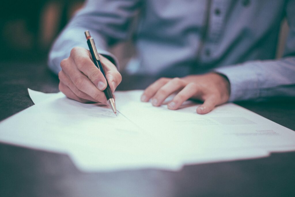 A man writing on paper at a desk