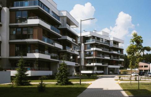 A city skyline with multifamily buildings under a calm sky