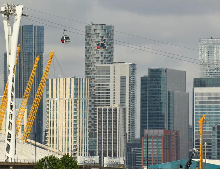 This photo shows buildings with cranes rising in an urban skyline.