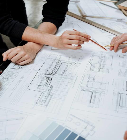 This photo shows professionals reviewing a floor plan together.