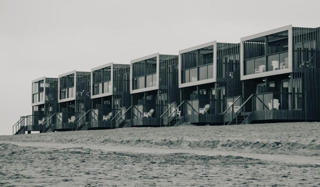 Row of beachfront apartment buildings symbolizing long-term real estate investment