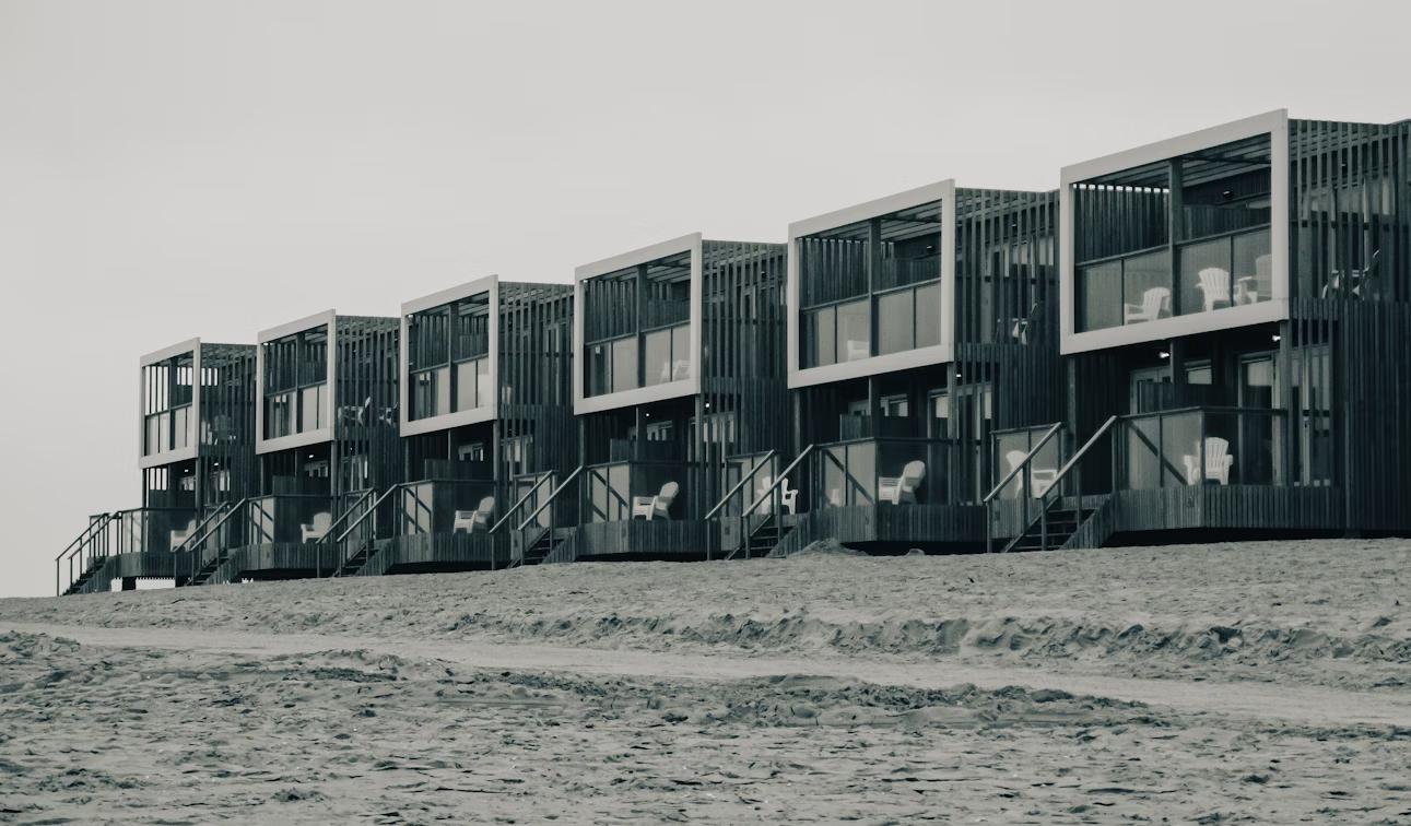 Row of beachfront apartment buildings symbolizing long-term real estate investment