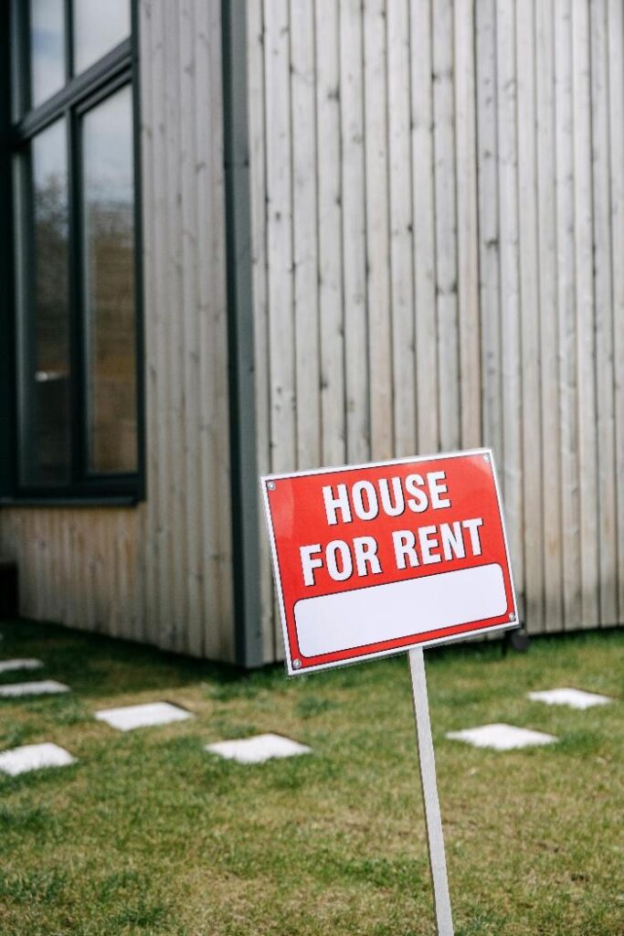 House for rent sign displayed in front of a residential property