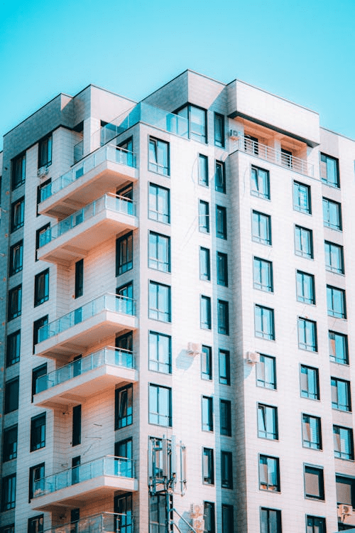 A high-rise concrete apartment building with balconies
