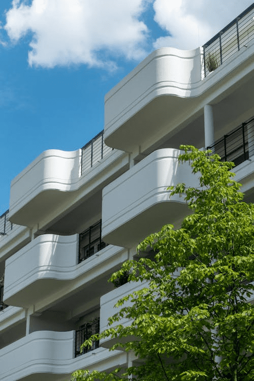 A low-angle picture of an apartment building with balconies