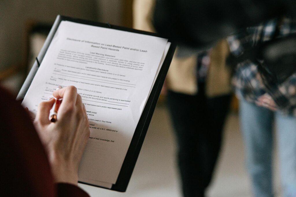 a real estate agent filling form for a couple