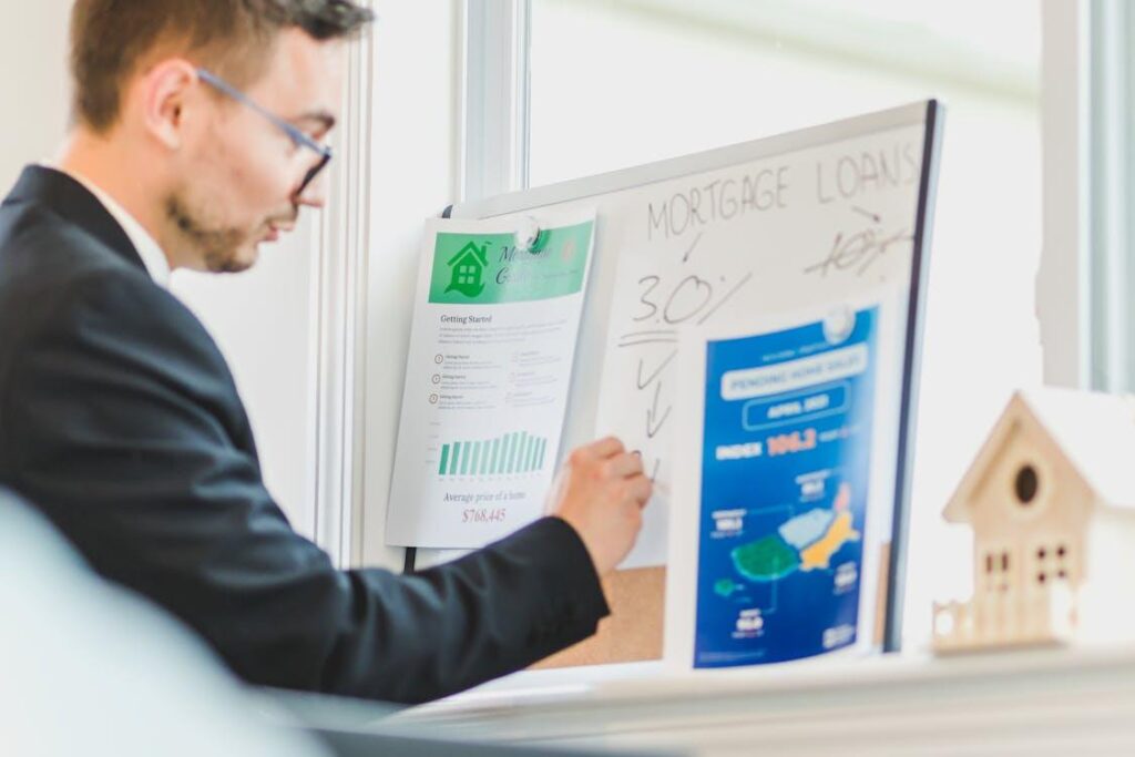an agent evaluating a property's value on a whiteboard
