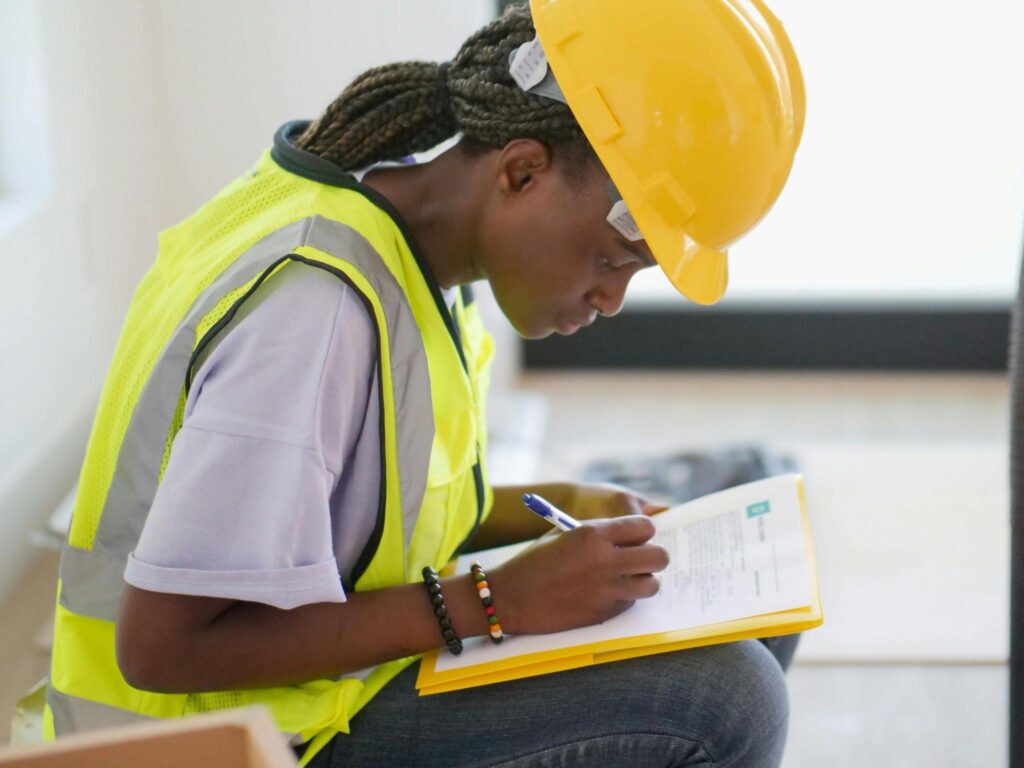 a female worker making notes on a construction plan