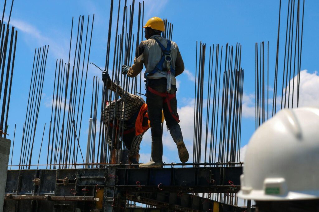 construction workers standing on a metal structure