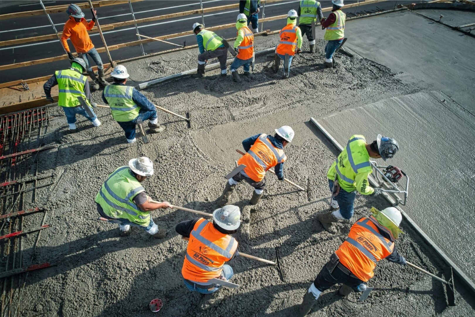 Construction workers leveling cement