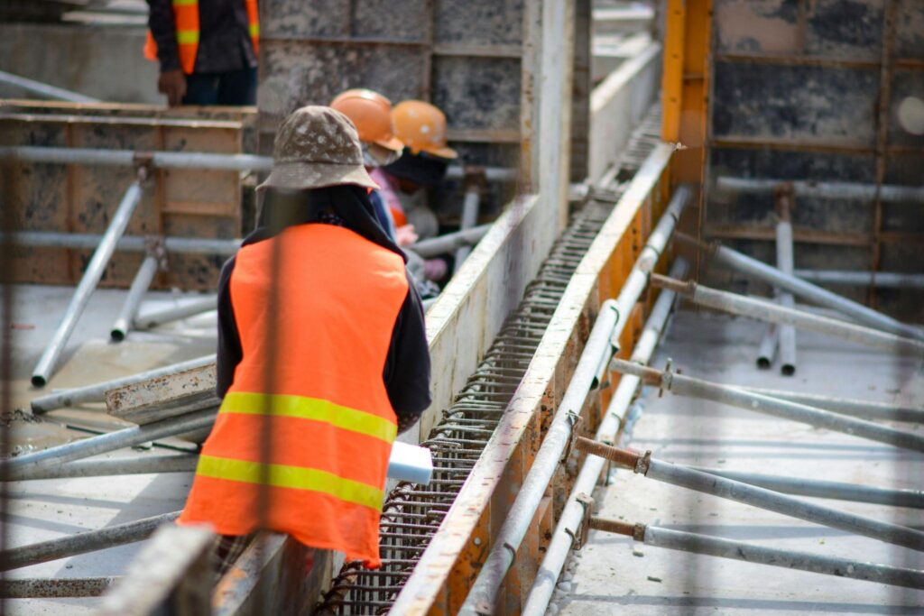 A worker in an orange vest on a construction site