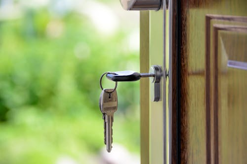 Key inserted into a house's main door symbolizing property ownership