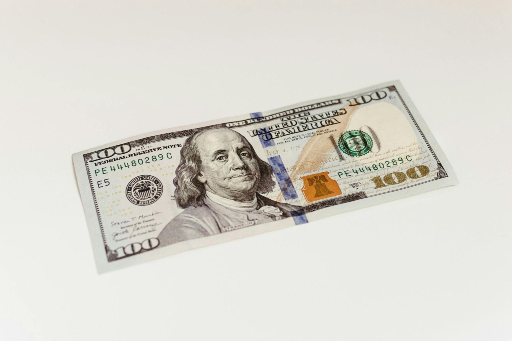 Close-up of a one-hundred-dollar bill on a white surface