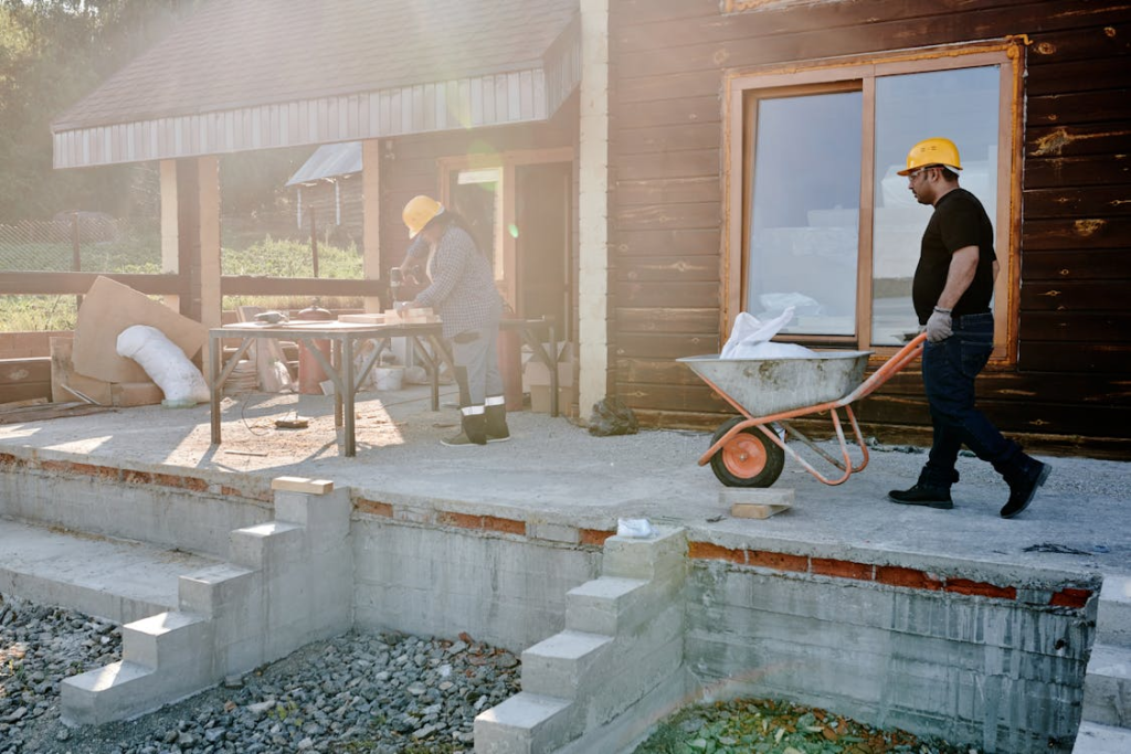 A residential property undergoing renovation by construction workers
