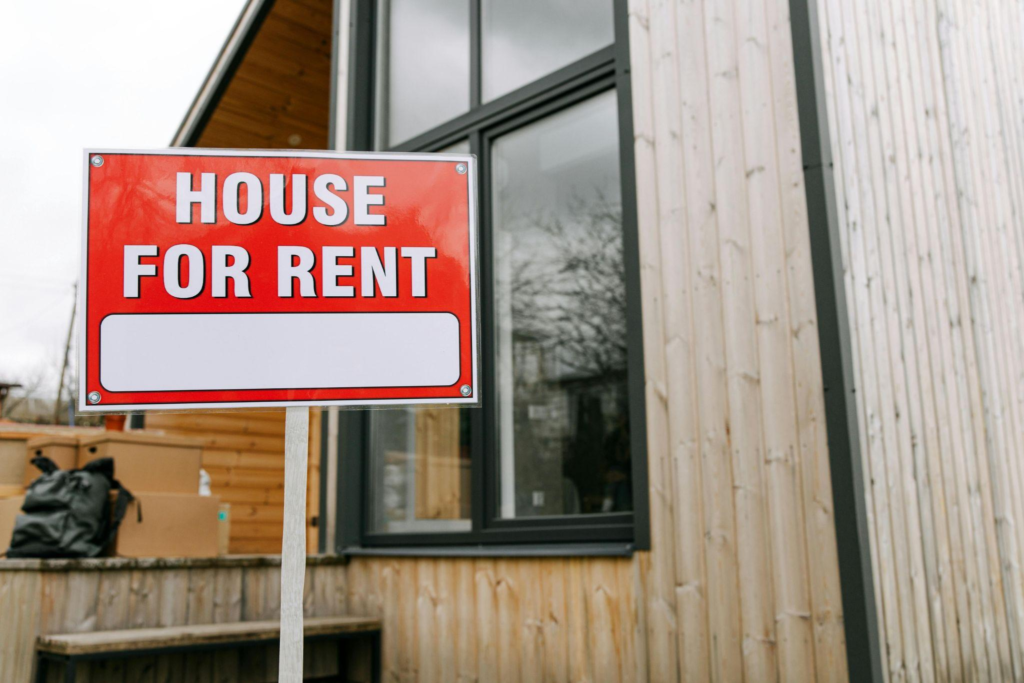 House with a for rent sign outside