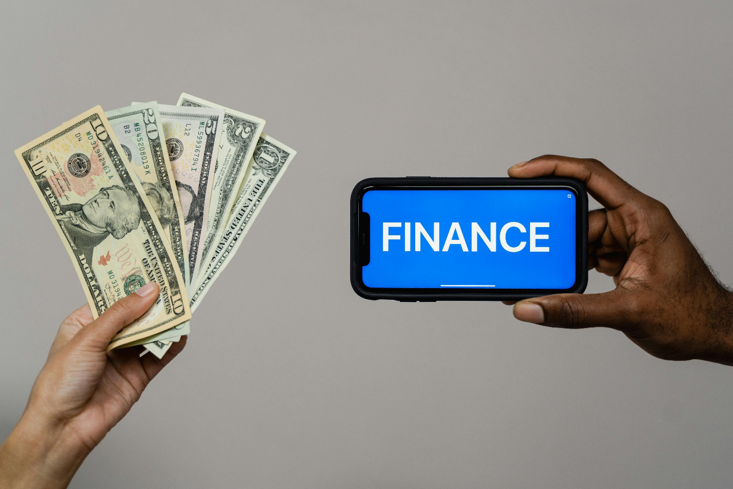 Person holding cash and phone