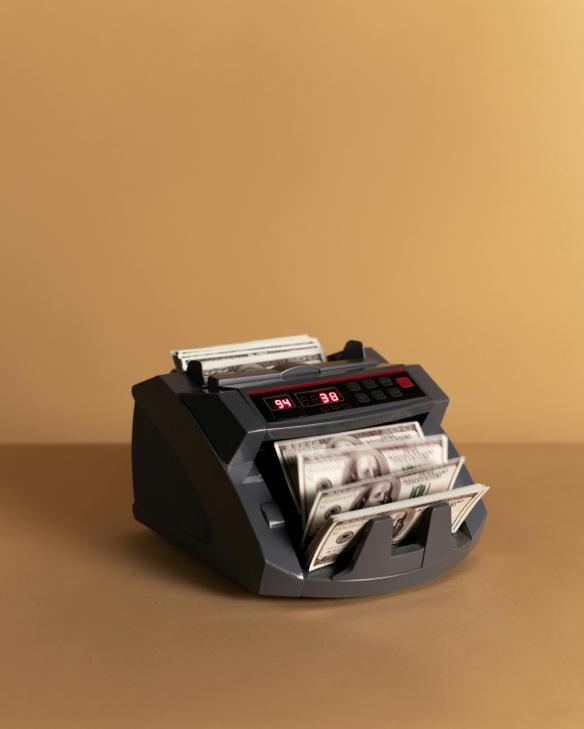 Banknote counter processing cash for real estate investment financing