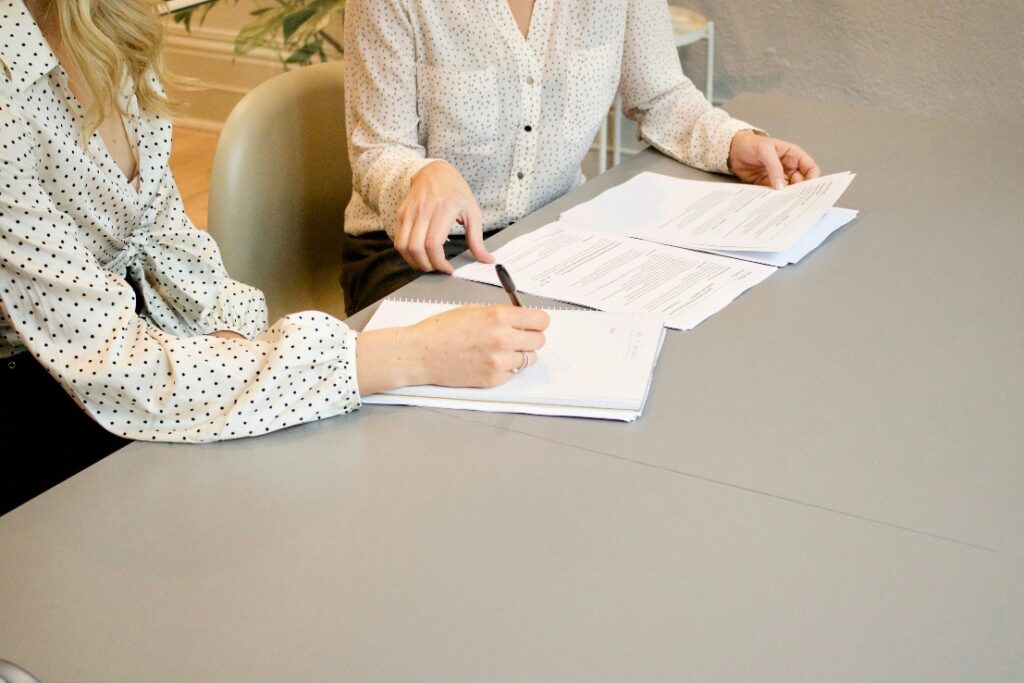 A person signing papers and more