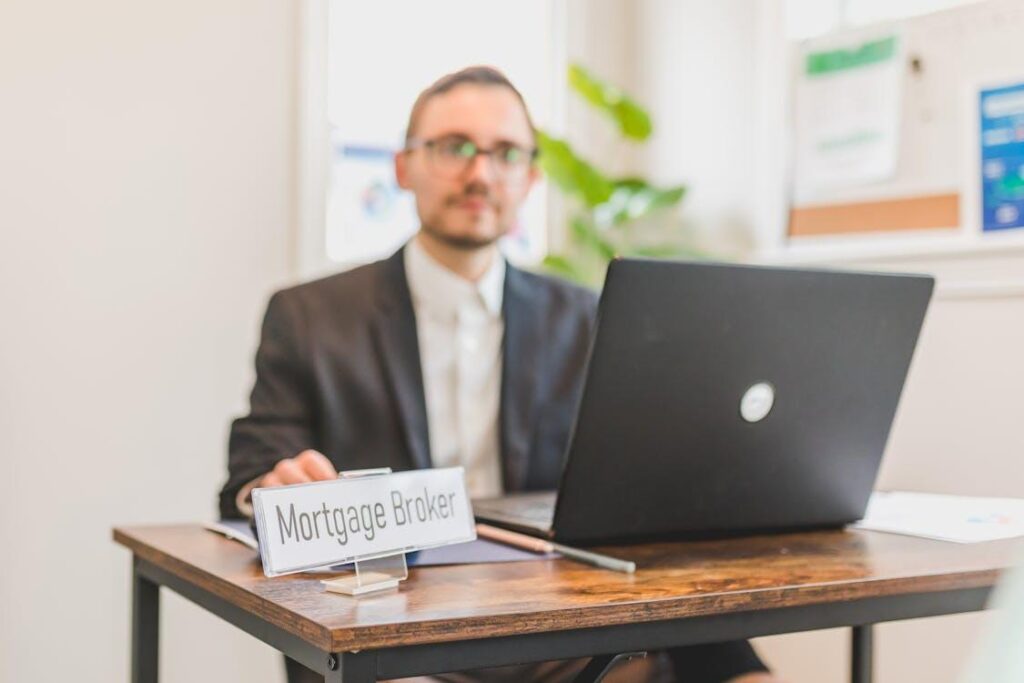 Mortgage broker discussing financing options from behind a desk