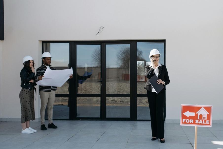 Investors and buyers standing outside a house listed for sale