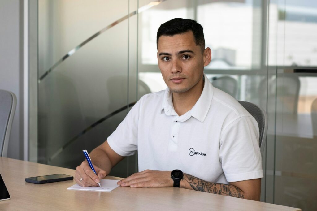 A person signing a contract in a large office