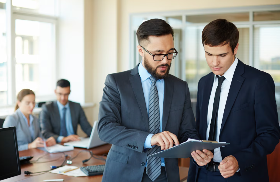 Lender and investor discussing portfolio loan strategy using a property model