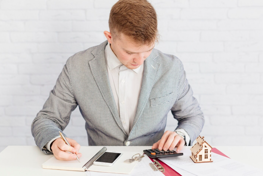 Real estate investor calculating rental portfolio loan metrics and performance data