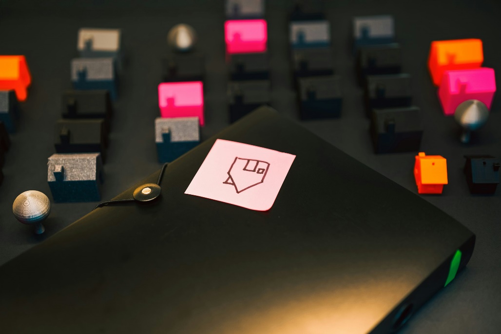 A post-it note with a home drawn over it