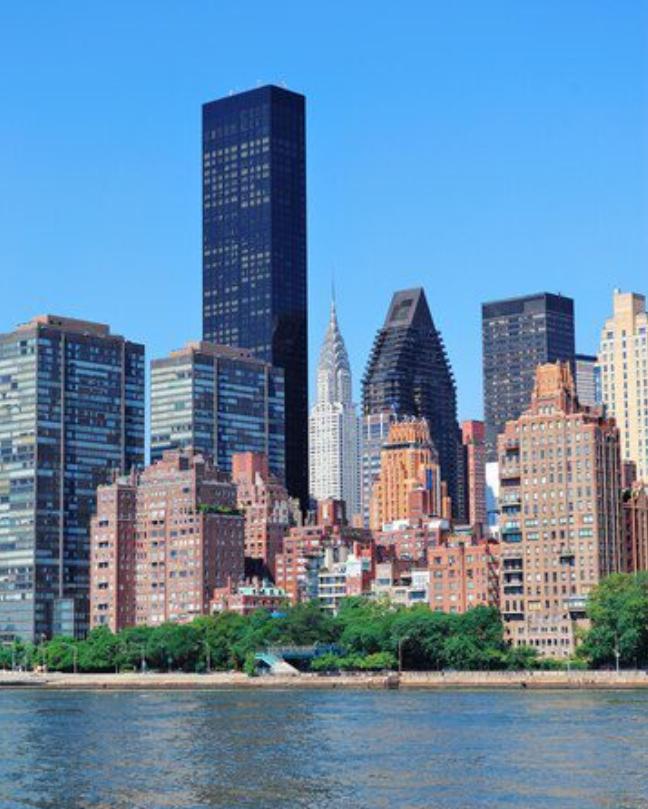 A large city skyline near the ocean
