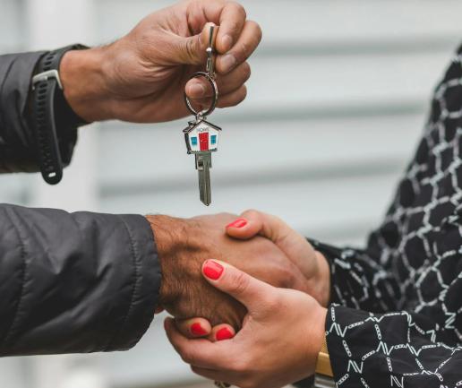 This image shows a handshake and a set of keys
