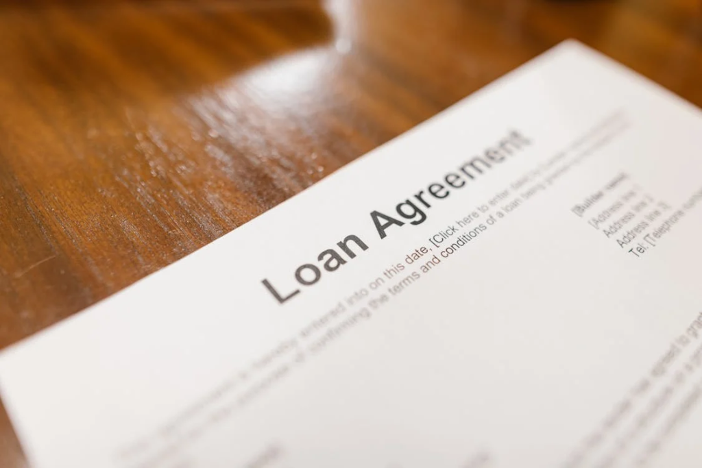 Close-up of signing a financial agreement for a real estate loan