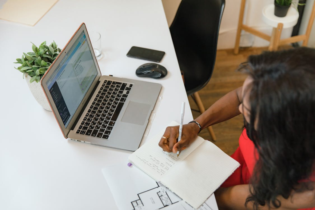 Investor reviewing financial notes and rental income projections in office