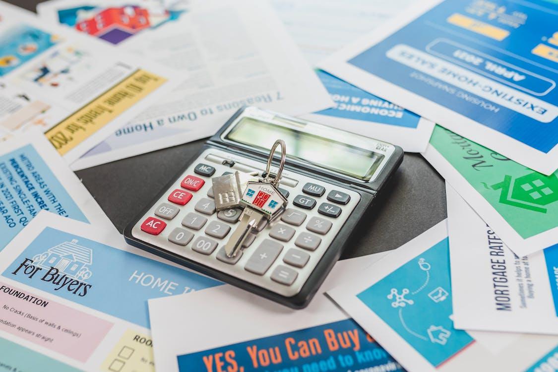 a calculator with a key placed in the center of the property flyers