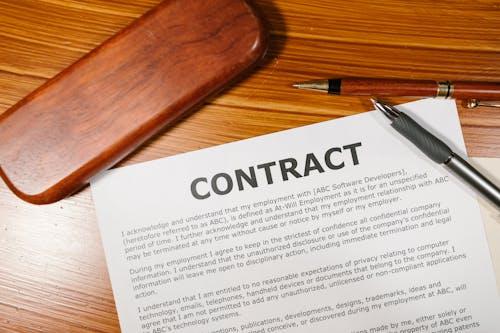 A close-up view of a contract and pen